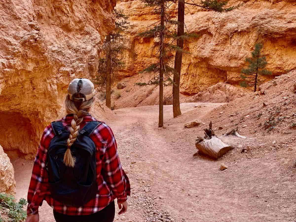 Zion To Arches National Park Woman hiking Navajo Loop Trail in Bryce Canyon National Park