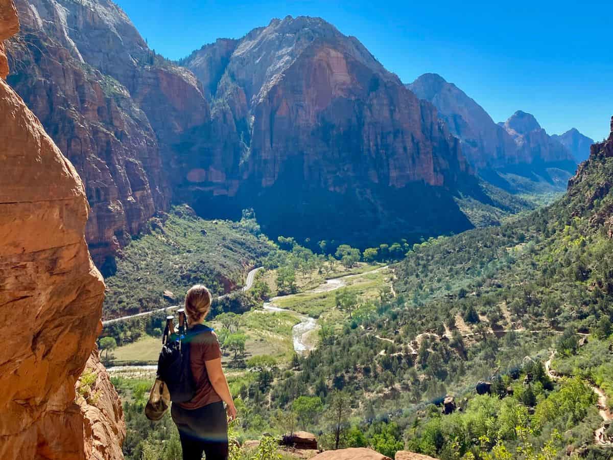 Zion To Arches National Park Woman hiking Angels Landing overlooking Zion Valley