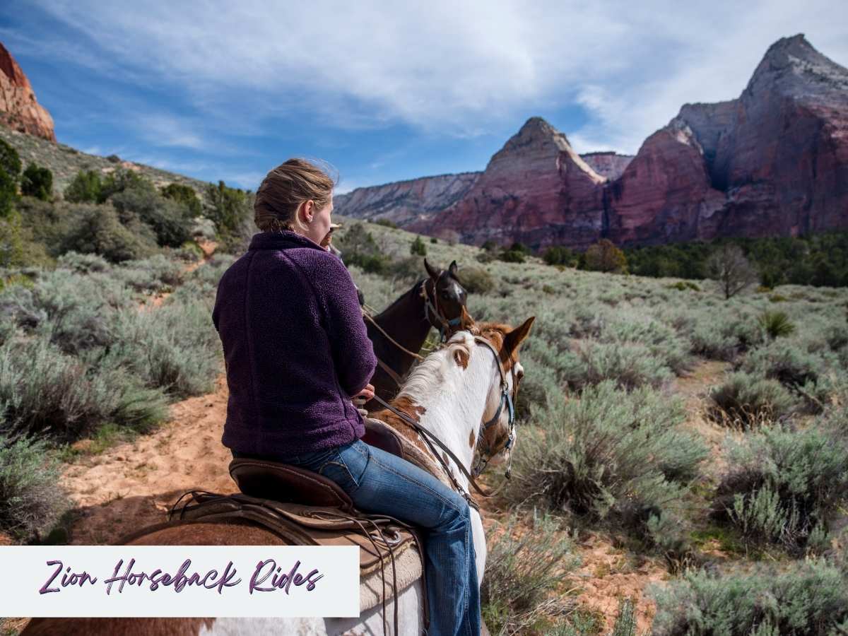 Woman riding a horse along a desert trail surrounded by sagebrush, with red rock cliffs and blue skies in the background, highlighting horseback riding as one of the best things to do in Zion National Park besides hiking. Text overlay reads “Zion Horseback Rides.”